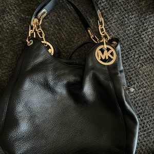 Michael Kors black and Gold hobo style bag.
